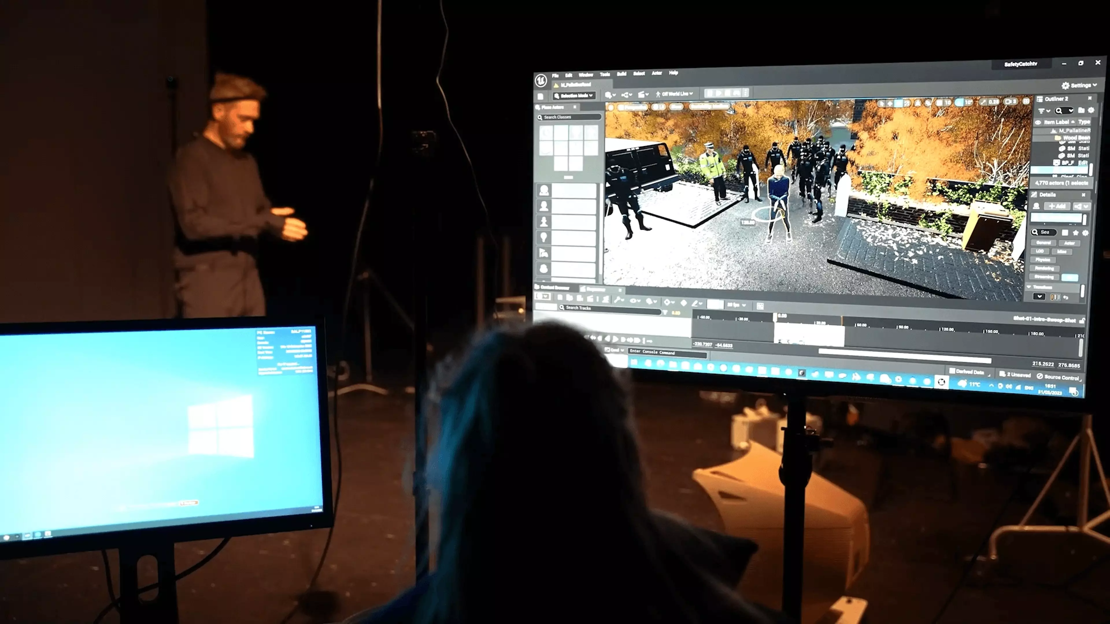 A VR animator creates an immersive 3D environment on a computer, while a motion capture artist, outfitted in a motion capture suit, performs movements for animation.