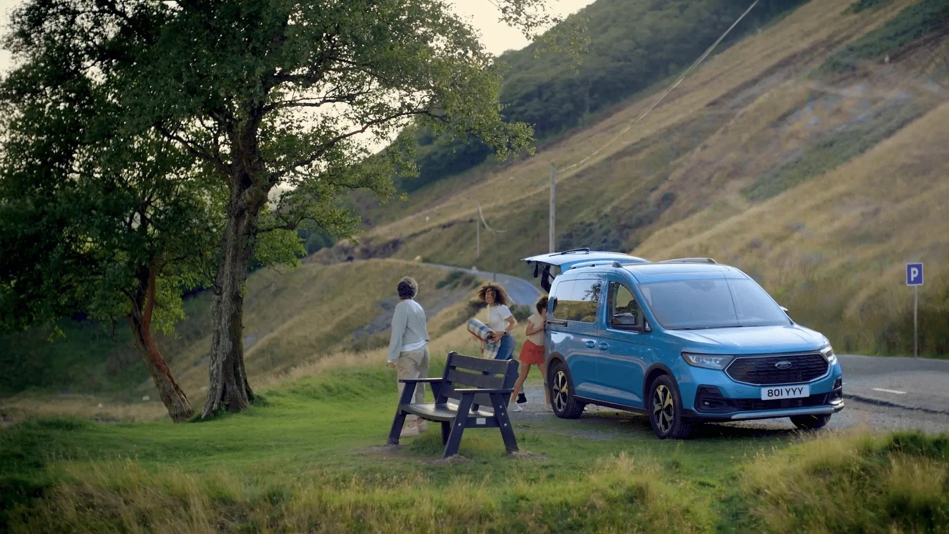 From the 'AS VERSATILE AS YOU ARE' Ford Tournero Connect commercial directed by Davy Lazare. A family parked by the mountain roadside get picnic items from their Ford car boot. 