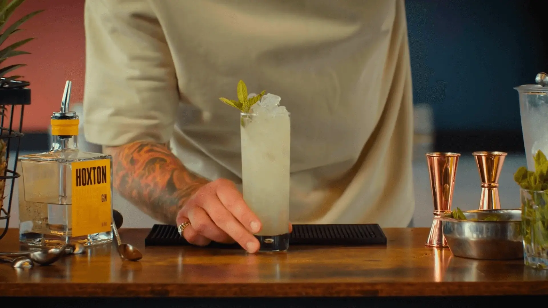 A close-up shot of a cocktail maker serving a Long Island Ice Tea in the Hoxton Spirits cocktail spot, directed by Davy Lazare.